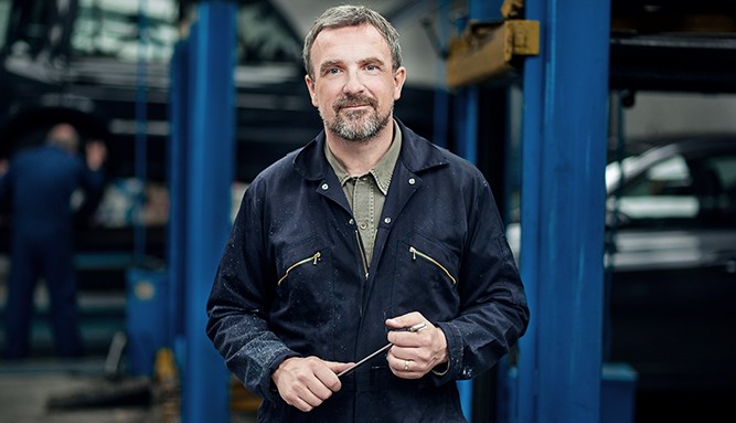 Mechanic-Standing-In-Garage