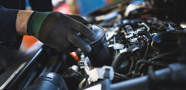 Mechanic-Removing-Oil-Filter-from-Car