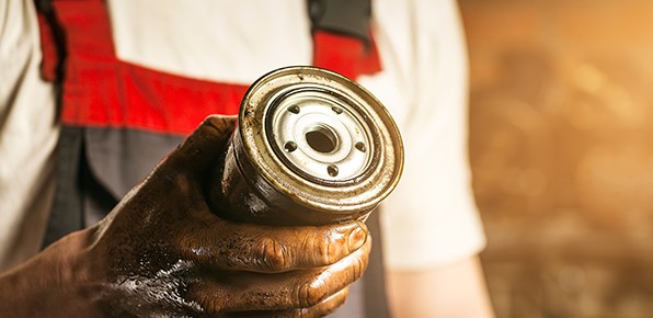 Mechanic-Holding-Dirty-Oil-Filter